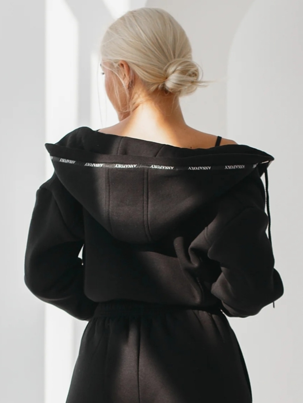Off-Shoulder Black Hoodie with Subtle Logo Trim